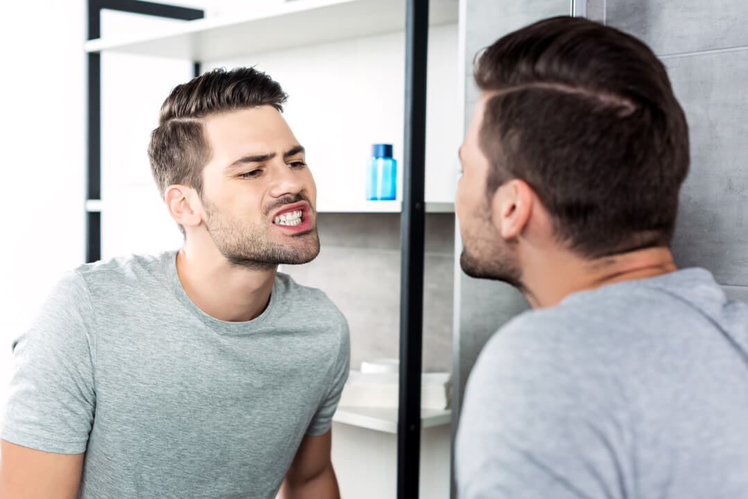 man.looking.at .teeth 1 Vaccaeo Aesthetic