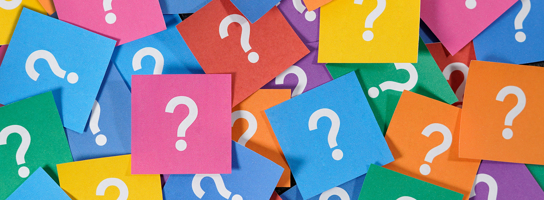 The image shows a collection of colorful sticky notes with question marks on them, arranged in a pattern against a neutral background.